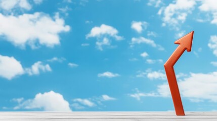 Fototapeta premium An upward arrow in vibrant orange pointing towards the blue sky symbolizes growth, success, and aspiration in business and personal development.