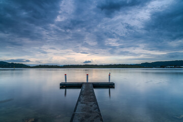 Obraz premium Before the rain sunrise waterscape with overcast sky