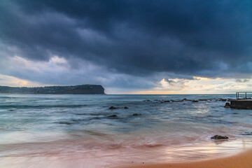Cloud covered sunrise at the seaside