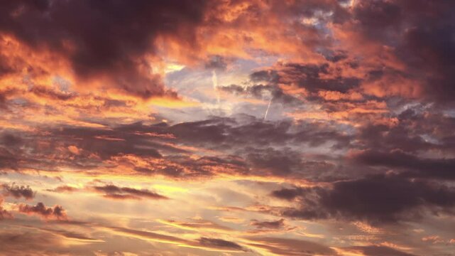 Timelapse shot of the movement of clouds at sunset. Autumn red sky at magic hour. 4K