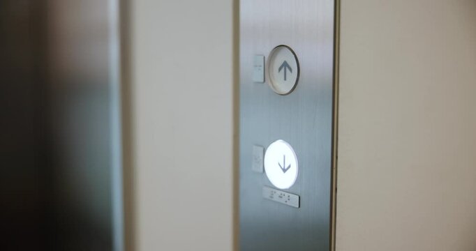 Hand, pressing and button for elevator in office building for floor, selection and lift request. Businessman, click and arrow for down, activation and closeup as accountant for company or corporate