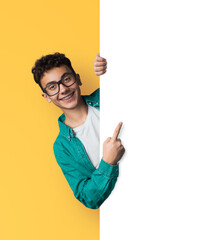 Young man wear eyewear glasses, braces, tooth brackets, stand behind, peep from blank empty banner...