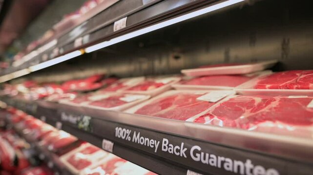 Perspective view of supermarket meat aisle displaying packaged cuts of fresh meat emphasizing quality assurance. supermarket meat aisle