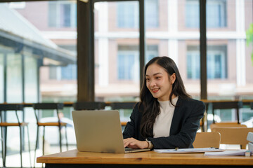 Asian businesswoman working with a laptop at the office.