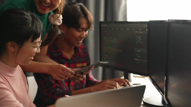 Slow motion back end software developer engineer for computer programming working together on debugging writing computing code, solving complex algorithms display on monitor in office. Burgeoning
