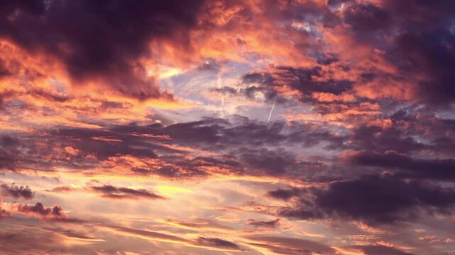 Timelapse shot of the movement of clouds at sunset. Autumn red sky at magic hour. 4K