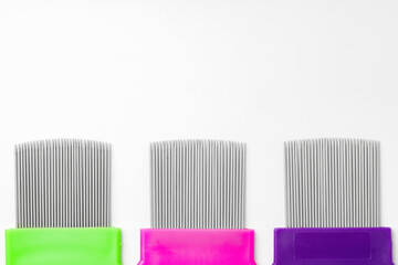Colorful plastic and metal combs on a white background