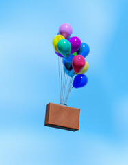 Brown suitcase floating in blue sky using colorful balloons as hot air balloon