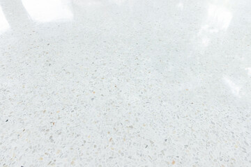 White terrazzo floor in perspective with clean, bright surface reflection with light. Polished smooth on surface from architecture design to decoration interior exterior. Empty space for background.