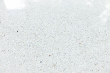 White terrazzo floor in perspective with clean, bright surface reflection with light. Polished smooth on surface from architecture design to decoration interior exterior. Empty space for background.