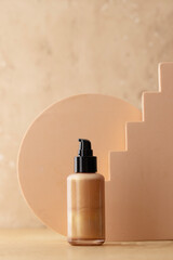 Shimmer body lotion bottle on beige background with geometric form, still life ads for visual content on smm
