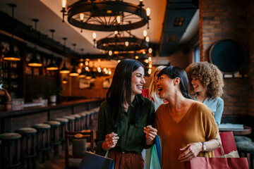 Beautiful women with shopping bags in the city cafe, shopping, tourism and happy people concept