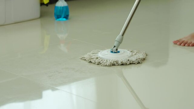 A young woman cleans her desk at home, using a disinfectant spray and a wipe. She ensures a hygienic and organized workspace, emphasizing cleanliness and personal health in her routine