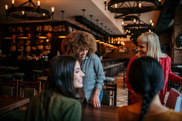 Friends having a good time, chatting in a restaurant