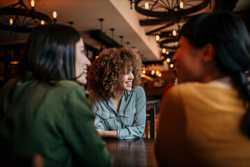 Friends having a good time, chatting in a restaurant