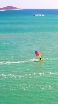 Vertical video of windsurfers - high quality aerial shot with drone of surfers windsurfing on Izmir beach in Aegean Sea Turkey Izmir