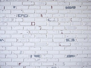 Distressed brick wall with a muted white and gray color scheme bearing visible signs of aging, brick, natural
