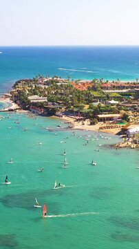 Vertical video of windsurfers - high quality aerial shot with drone of surfers windsurfing on Izmir beach in Aegean Sea Turkey Izmir