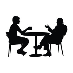 Two men sitting at a table. One man is drinking coffee. The other man is talking. There are two chairs