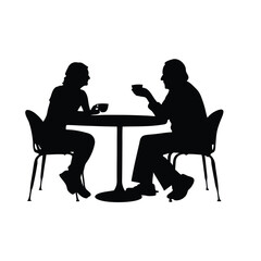 Two people sitting at a table. One of them is holding a cup. The table is round
