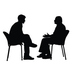 Two men are sitting in chairs and talking. One of the men is wearing a tie. The chairs are black