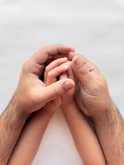Parent and child hands embracing. Symbol of love, protection, and family connection