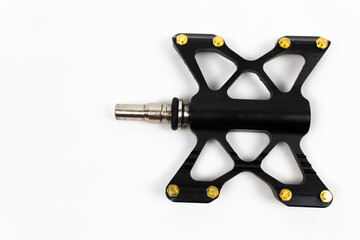 Unique bicycle pedals with iron material with gold bolts isolated on a white background