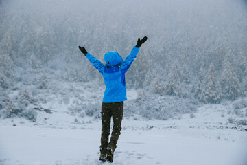 Asian woman enjoy the beautiful snowing landscape