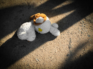 Teddy bear cement road with dark shadow, symbol child abuse violence sad domestic kid fear grief...