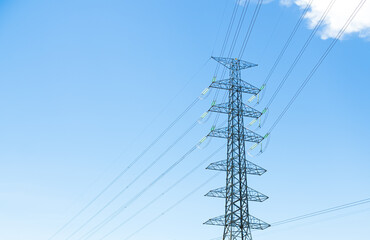 High voltage pole on blue sky background, cable electric voltage renewable energy pylon green technology industry electricity, ecology agricultural sustainable aerial power pole line generator.