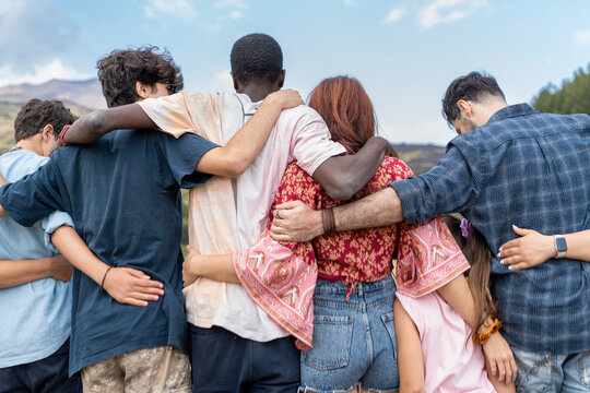 Young diverse friends embracing in nature showing multicultural community friendship youth empowerment and social bonding together