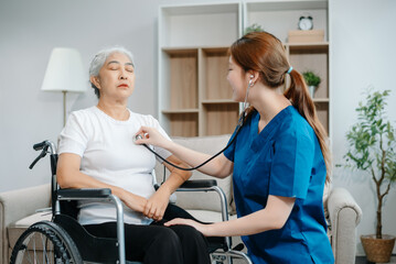 Obraz premium Asian caregiver doctor examine older patient woman therapist nurse at nursing home taking care of senior elderly woman sit on sofa.Medical service concept.