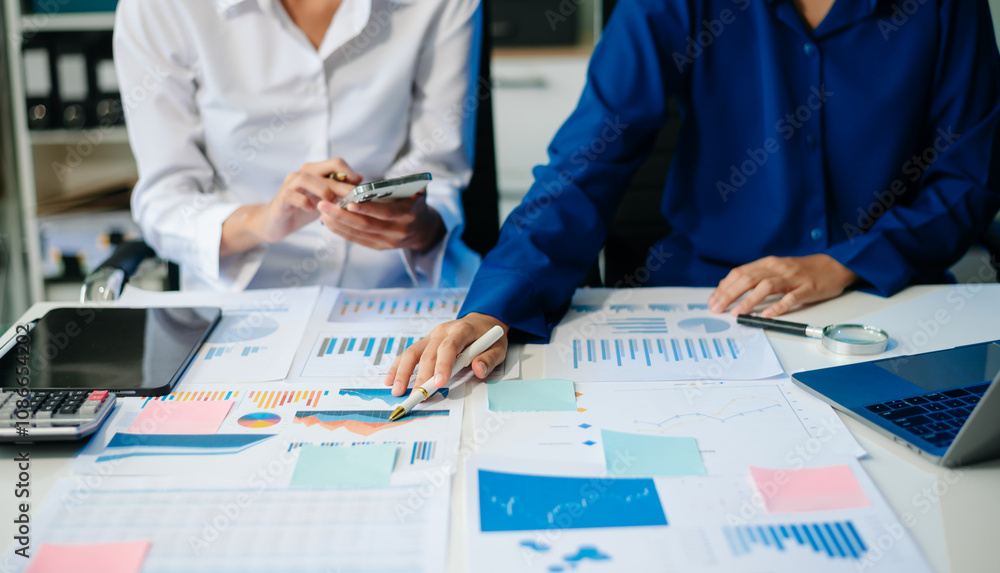 Poster business documents on office table with smart phone and calculator digital tablet and graph business