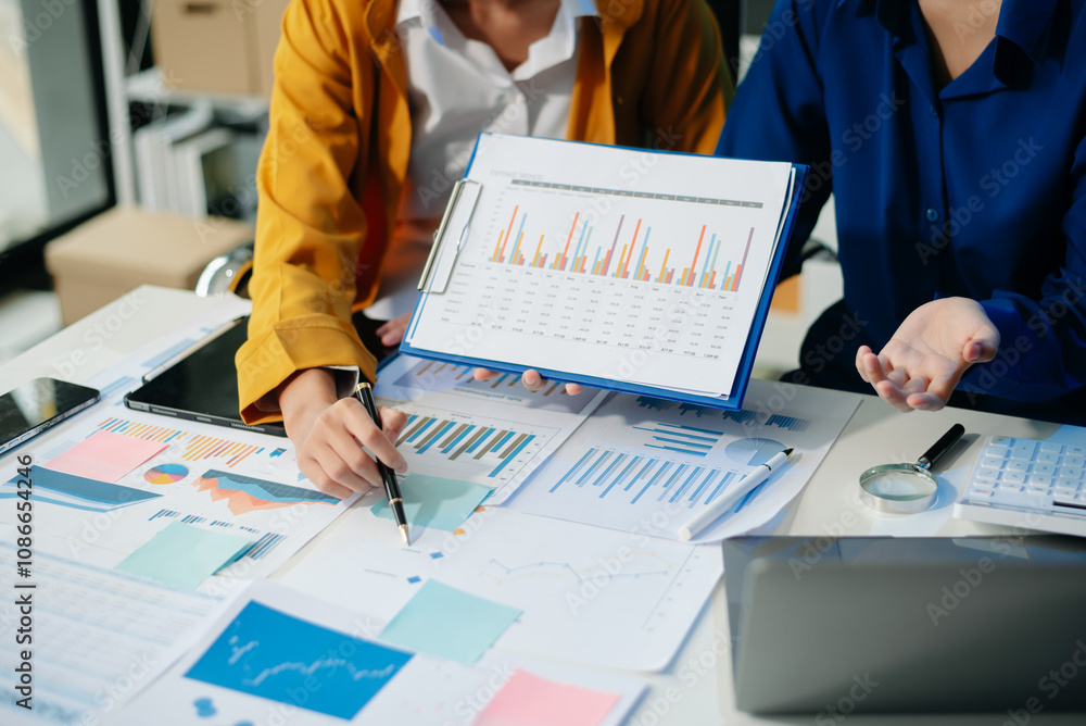 Poster business documents on office table with smart phone and calculator digital tablet and graph business