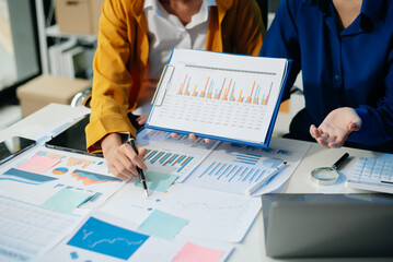 Business documents on office table with smart phone and calculator digital tablet and graph...