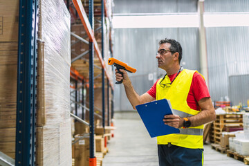 Warehouse worker scanning packages with barcode scanner