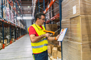 Warehouse worker scanning packages with barcode scanner