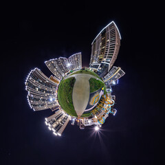 abstract swirling tiny planet spherical panorama of multi-storey buildings of skyscrapers of a residential complex in the form of a butterfly, bugs, crabs in in night sky