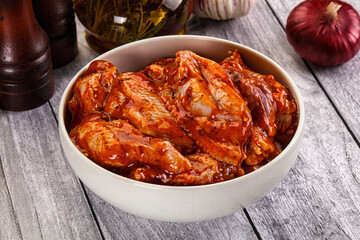 Raw marinated buffalo chicken wings