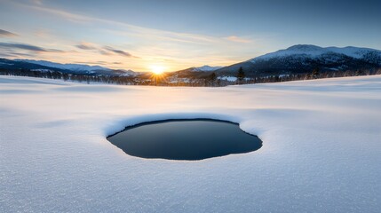 Tranquil winter landscape with a water hole at sunset