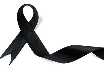 A black ribbon on a white background as a symbol of sadness, mourning or cancer awareness.