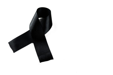 A black ribbon on a white background as a symbol of sadness, mourning or cancer awareness.