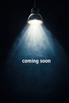 Spotlight shining on dark background with coming soon text