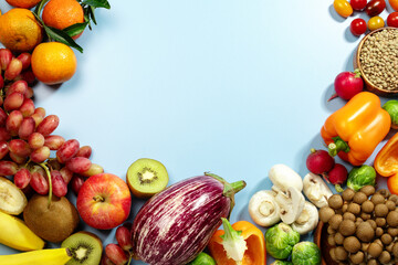 Food frame background on blue with vegan products, fresh fruits and vegetables, vegan food, top view