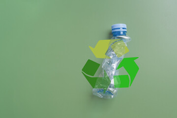 Used transparent plastic bottles crushed and crumpled on green background. Recycling  plastic utilisation concept