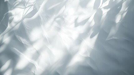 Obraz premium A soft, ethereal play of light and shadow on flowing white fabric.