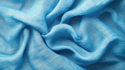 A close-up of light blue fabric with a delicate, airy texture, creating soft, flowing waves.