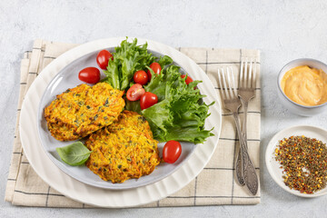 pumpkin carrot potato patties on plate, top view