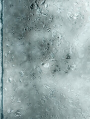 A detailed texture of moisture droplets on a glass surface, ideal for backgrounds and adding realistic elements to designs