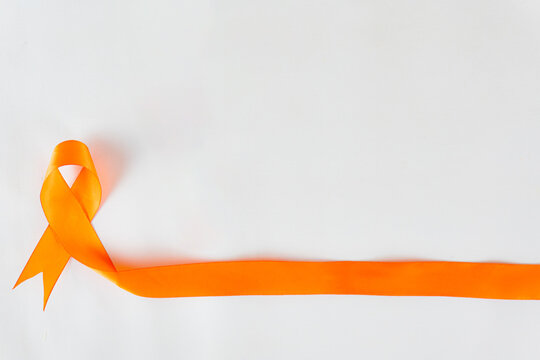 Orange ribbon on white background, national Skin Cancer Prevention Campaign. Orange ribbon as cancer awareness month.